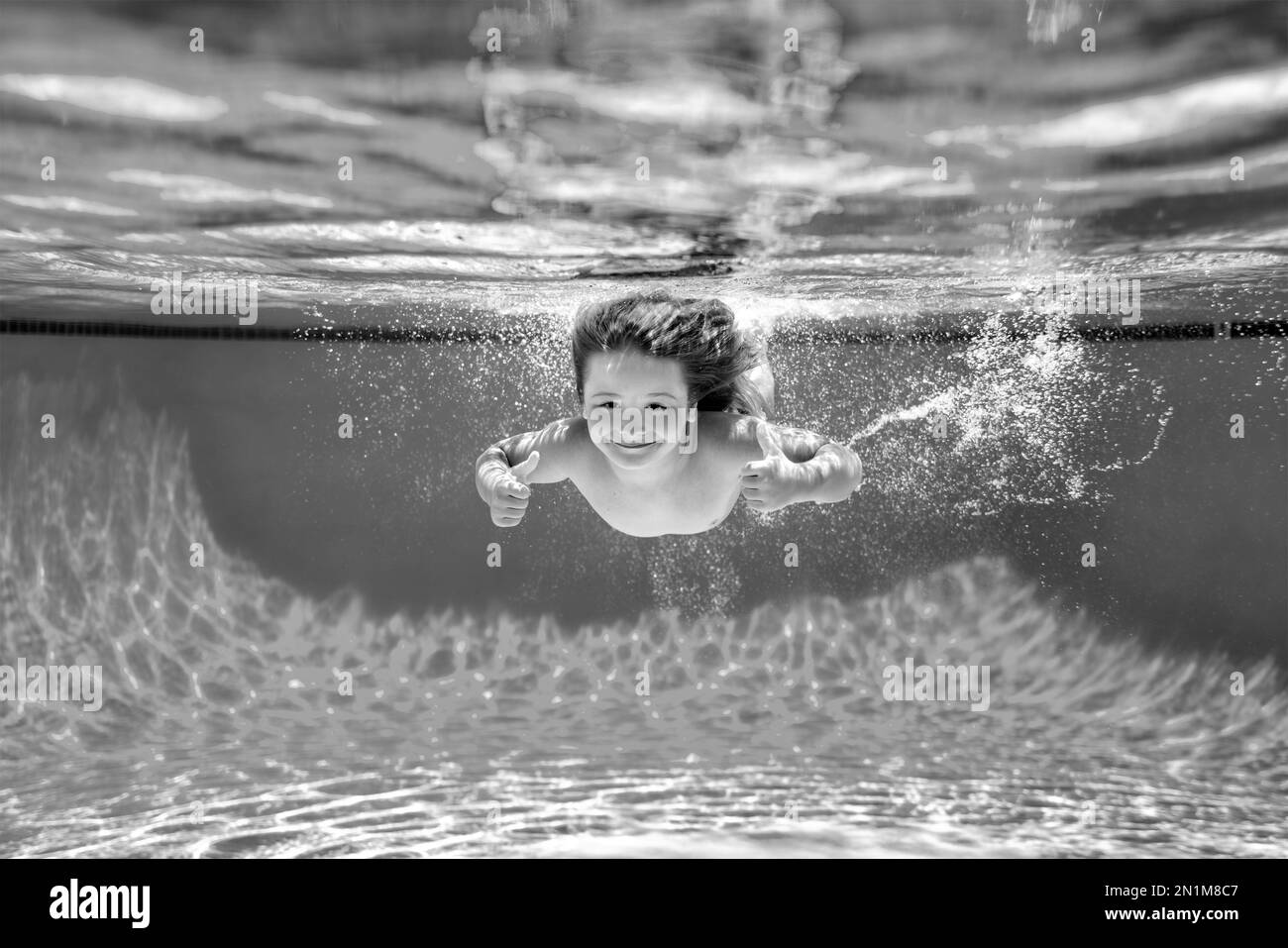 Child swim under water in sea. Kid swimming in pool underwater. Happy