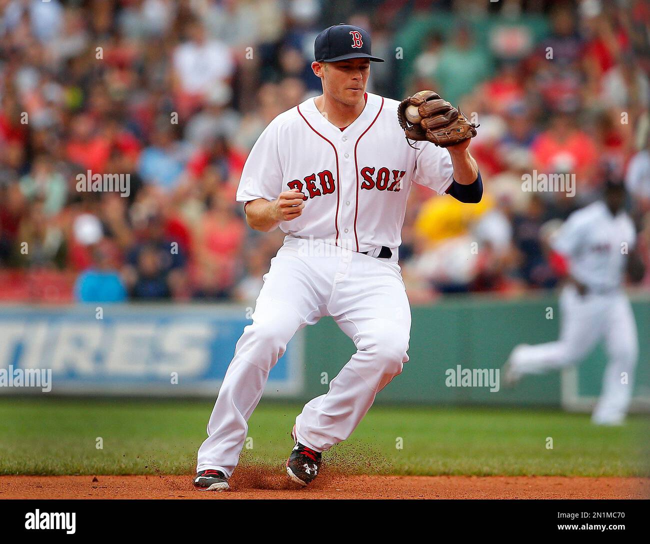 Boston Red Sox's Josh Rutledge grabs a ground ball against the Kansas