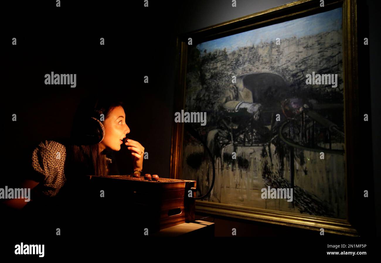 Tate Sensorium A member of the Tate Britain staff poses for photographers eating a ...