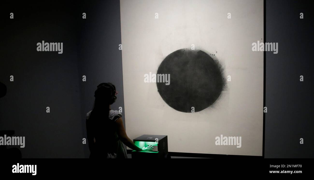 Tate Sensorium A member of the Tate Britain staff poses for photographers with her ...
