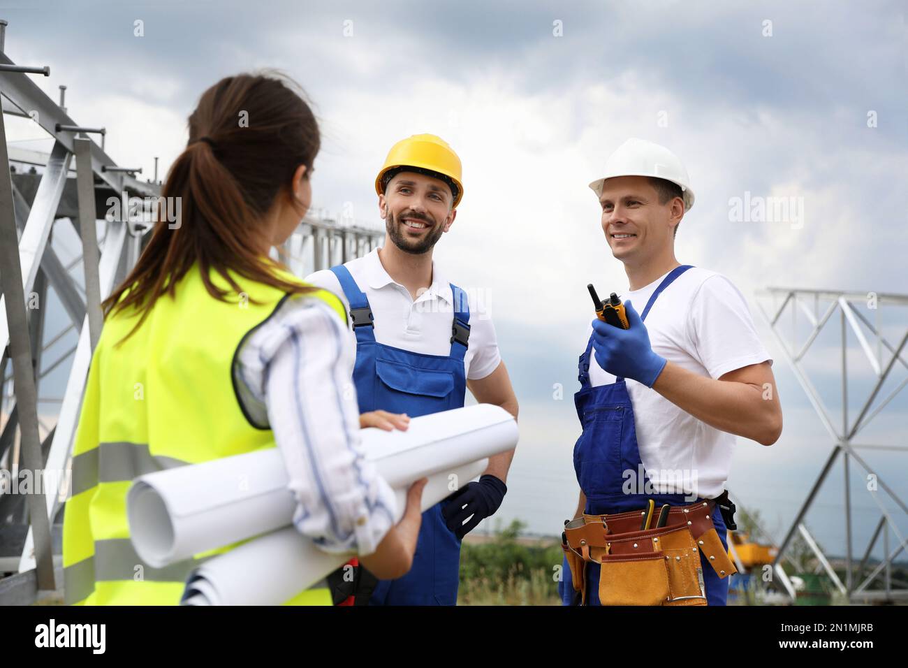 Professional engineers working on installation of electrical substation ...