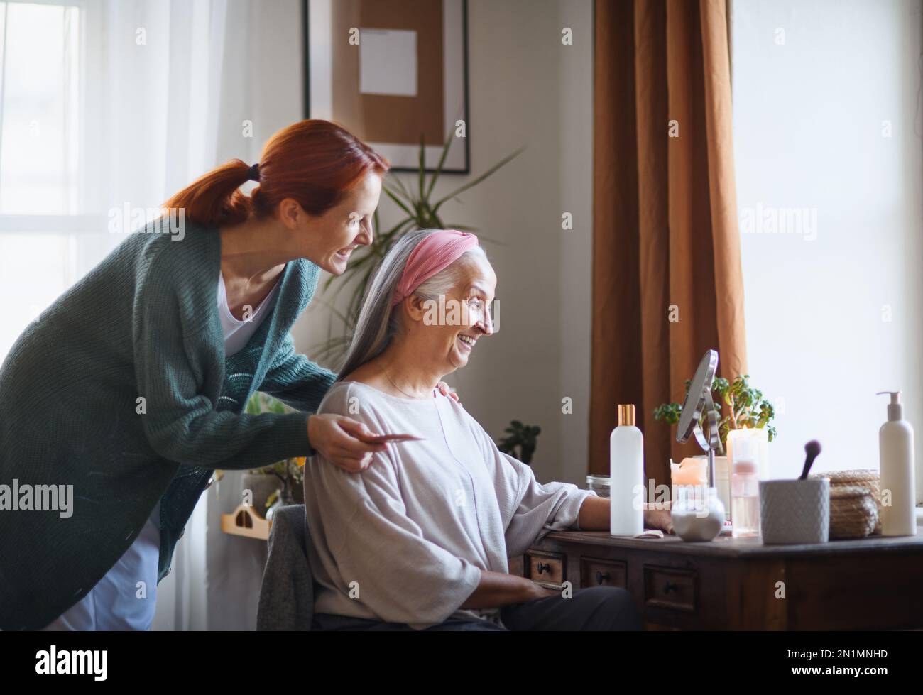 Caregiver helping her client with a make up Stock Photo - Alamy