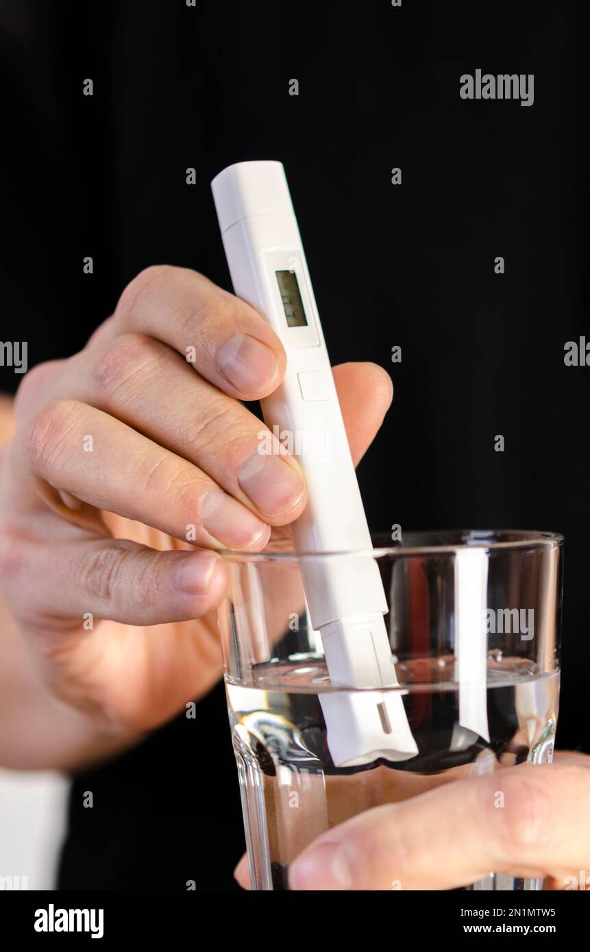 Water Quality Tester in a Glass of Water. Measuring the quality of