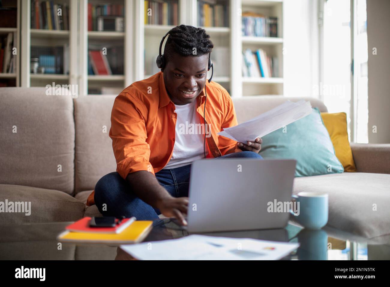 Young african man working from home, using computer Stock Photo