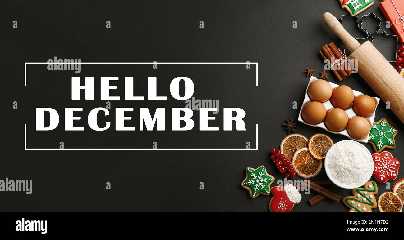 Hello December greeting card. Flat lay composition with homemade Christmas cookies and ingredients on black table Stock Photo