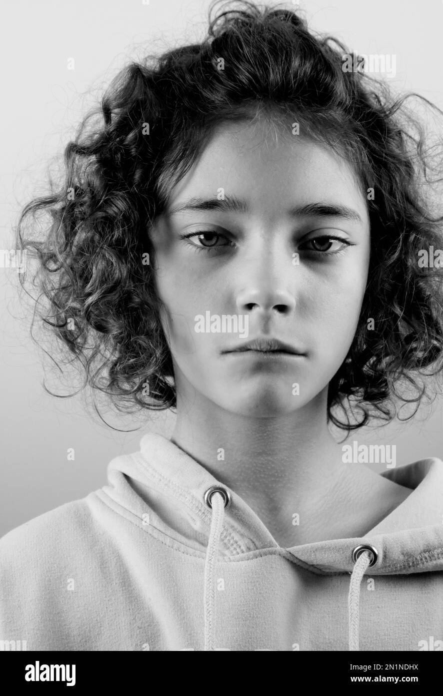 Black and white portrait of a genuine young girl with curly hair ...