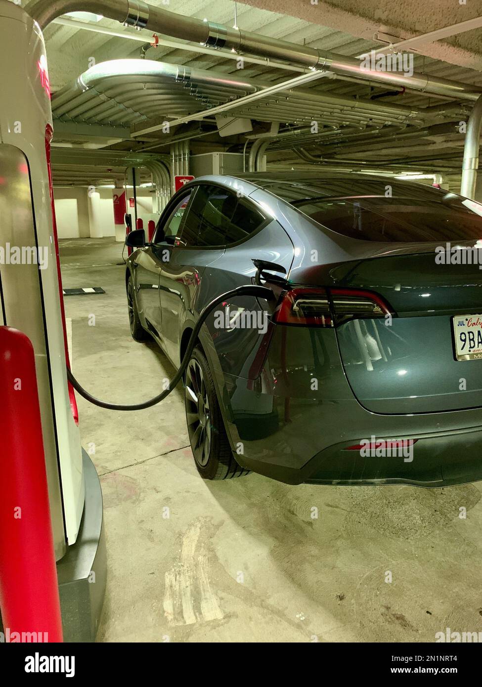 A Tesla EV at a Super Charger in California Stock Photo - Alamy