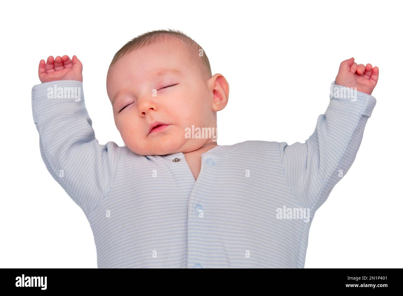 The infant baby sleeps in a star shaped pose with his arms spread out