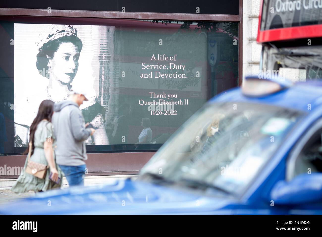 A portrait of Queen Elizabeth II is displayed in a shop window in ...
