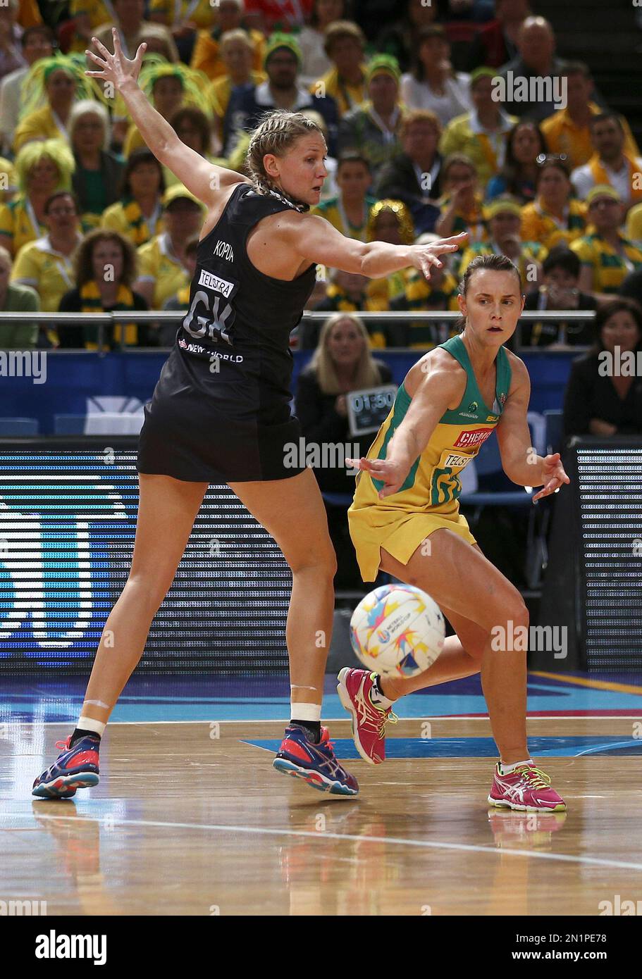 Australia's Natalie Medhurst, right, bounces the ball past New Zealand