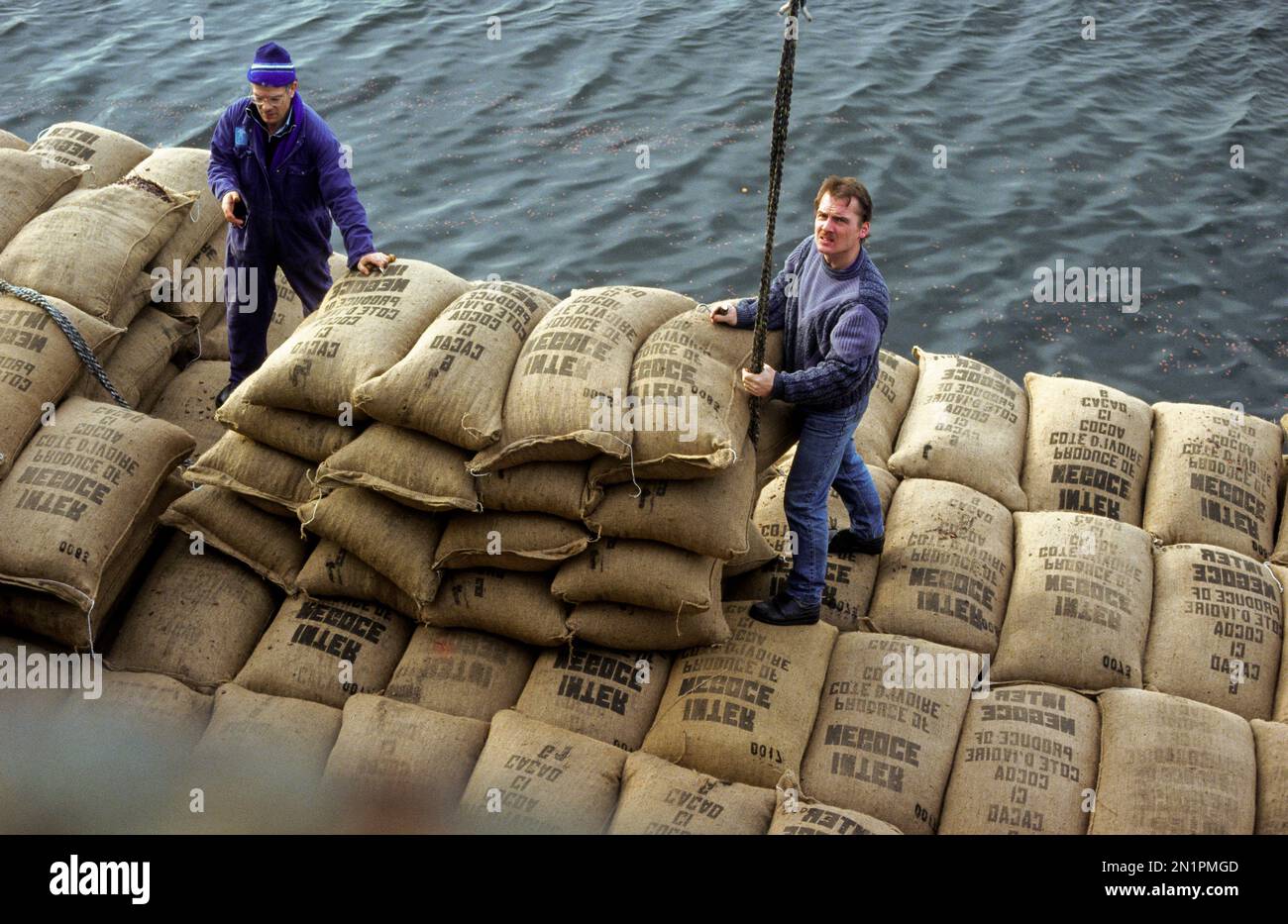 The Netherlands, Amsterdam. Loading cocoa into a ship. Stock Photo