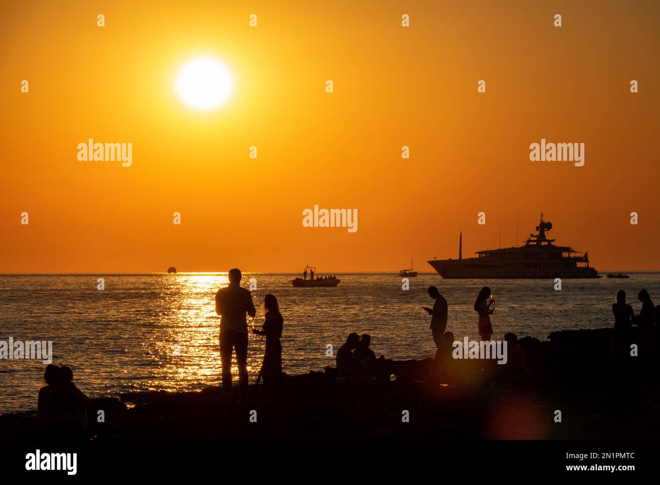 Standalone picture dated July 12th shows people watching the sunset in