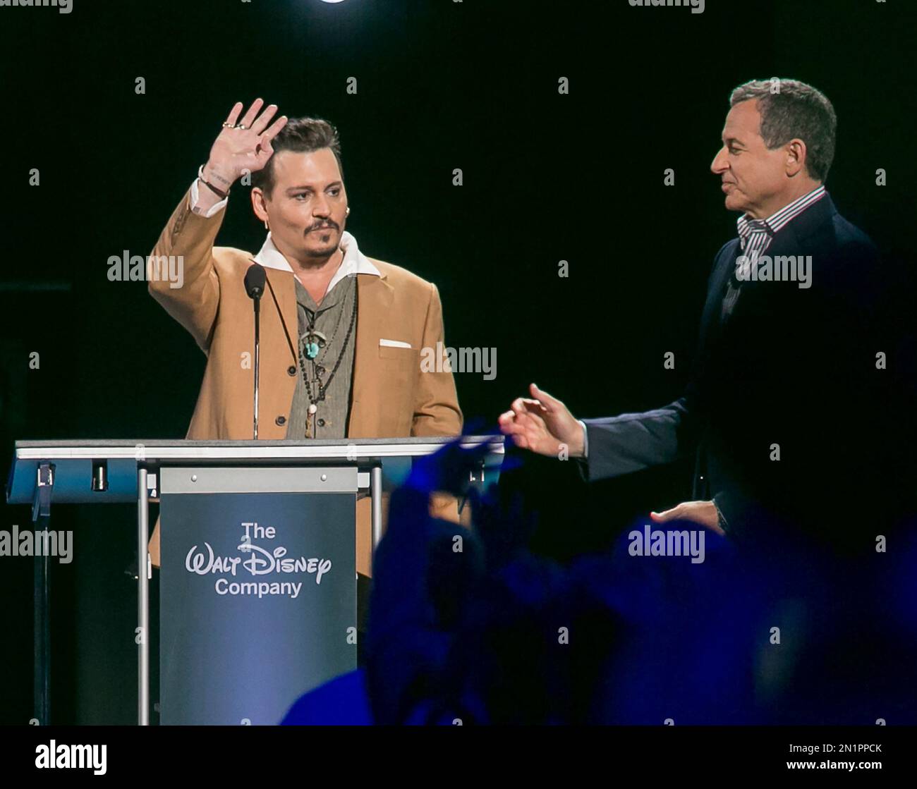 Actor Johnny Depp, left, makes a surprise appearance at Disney's D23