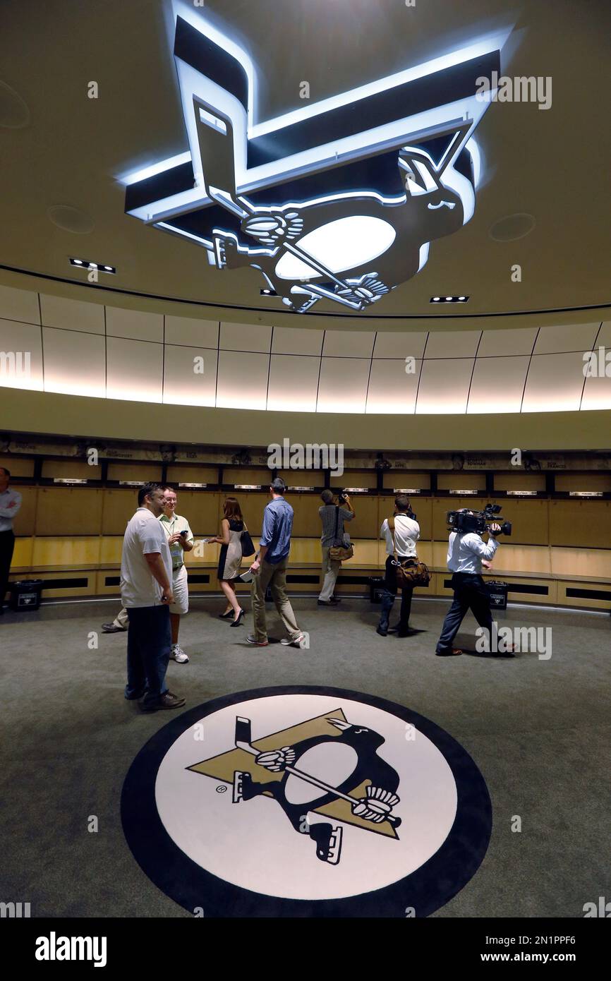 Photographers and reporters look through the locker room of the Pittsburgh  Penguins at the new state-of-the-art practice facility for the NHL hockey  team during a media tour Friday, Aug. 14, 2015 in, image size:866x1390