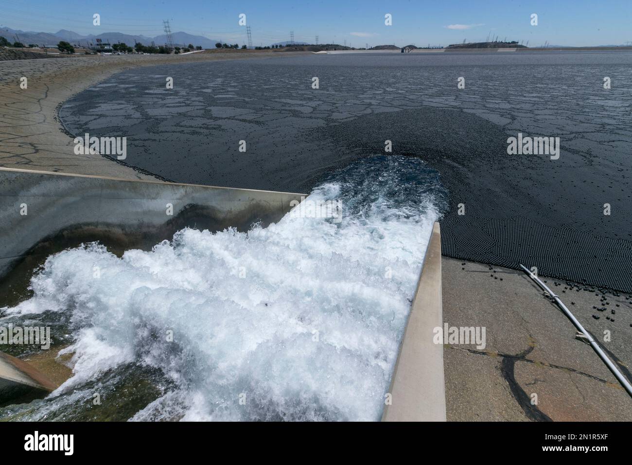Water flows into the Los Angeles Reservoir, which has been covered with