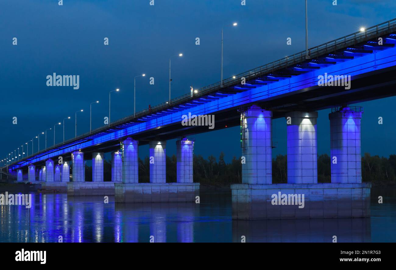 The New bridge with blue illumination at night. The bridge goes across the Ob in Barnaul, connecting the Central District of the city and the right ba Stock Photo