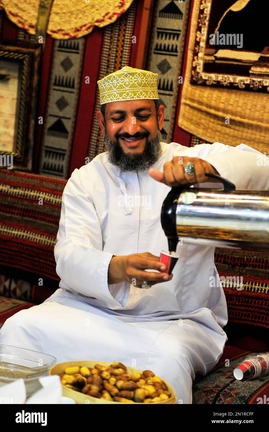 Omani man taking a coffee Stock Photo