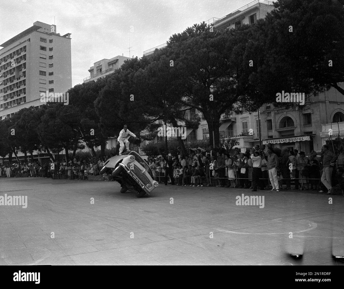 French stunt man, Jean Sunny, does a balancing act on a Simca Aronde ...