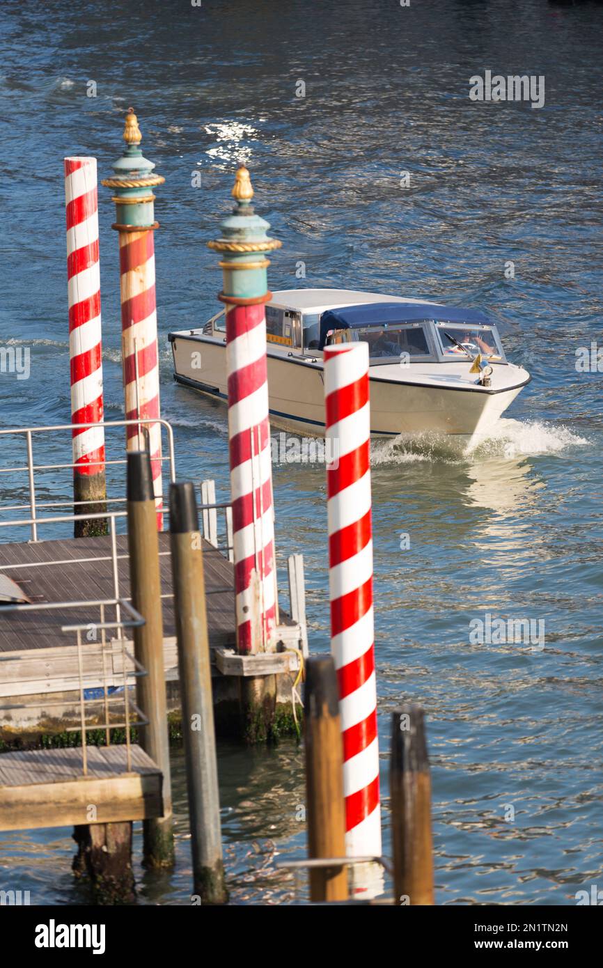 Italy, Venice, Godola/taxi mooring poles. Common throughout Venice. Stock Photo