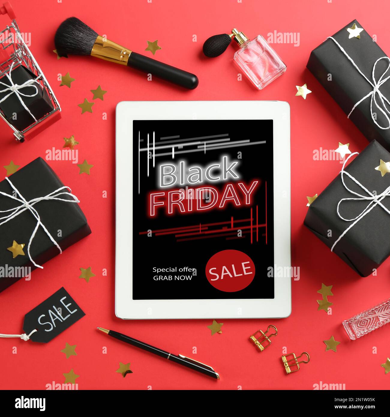 Fri Lay Flat lay composition with tablet, gifts and accessories on red ...