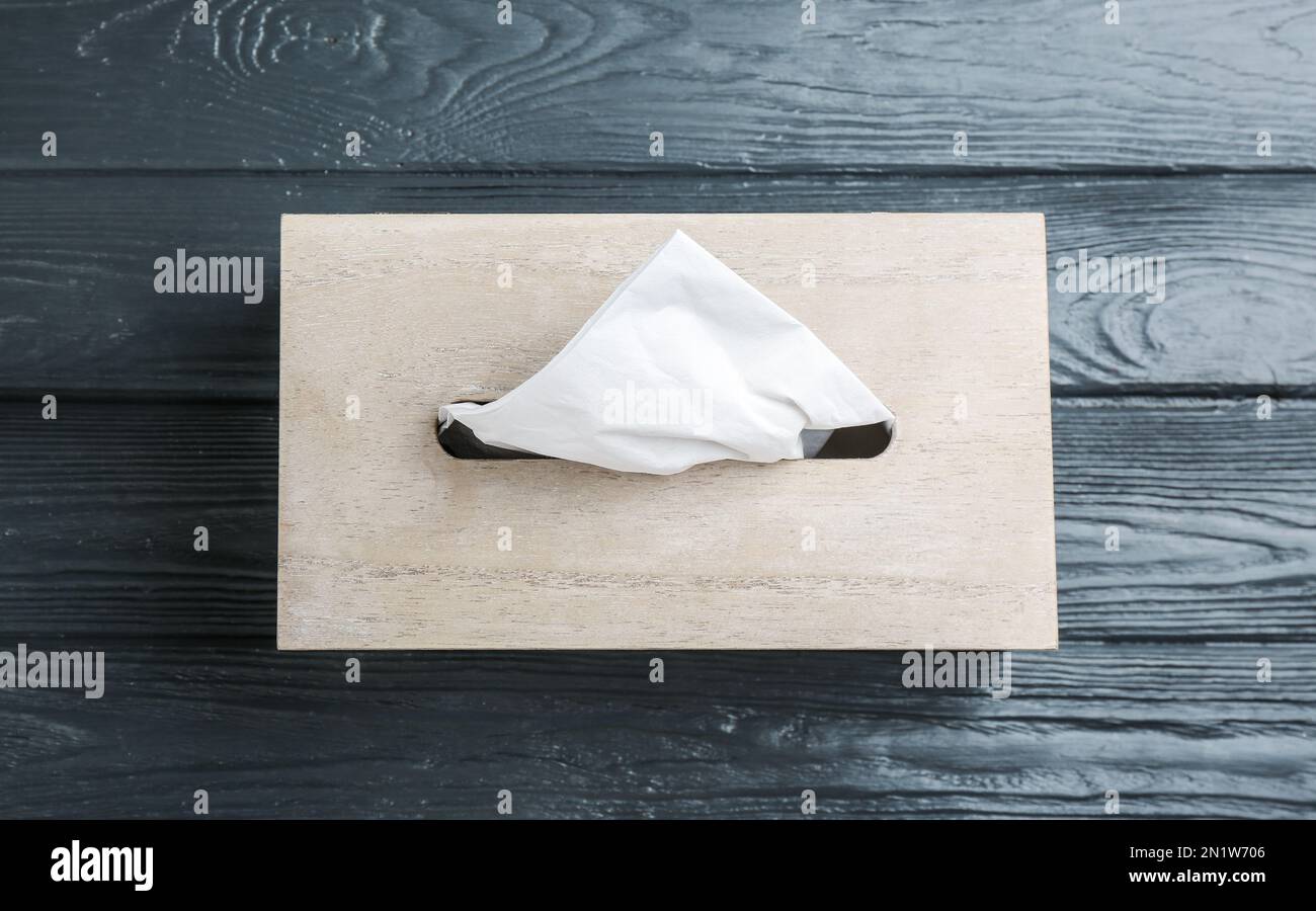 Box of tissues on grey wooden table, top view Stock Photo