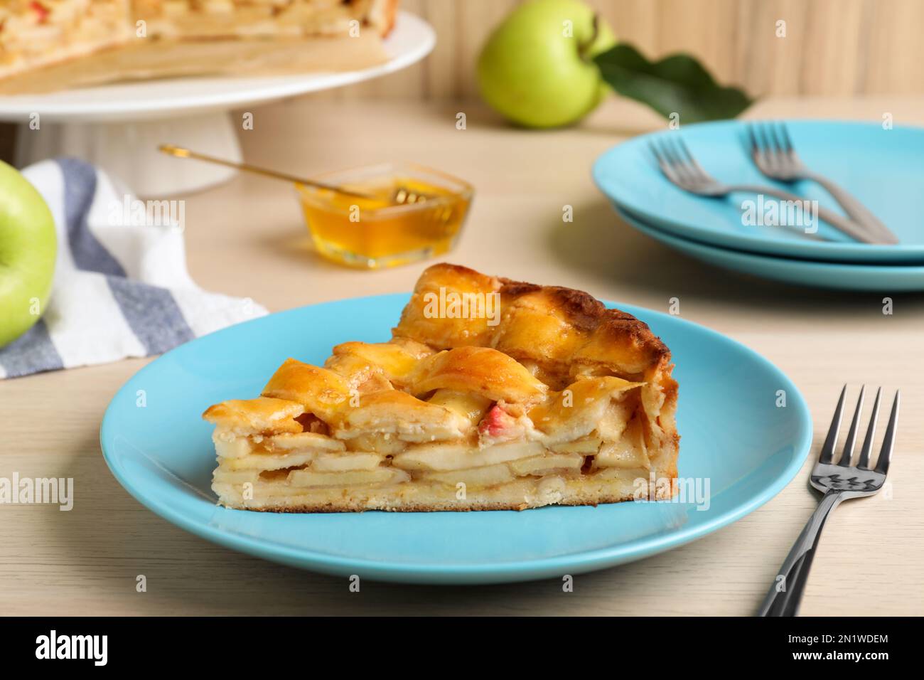 Slice of traditional apple pie on wooden table Stock Photo