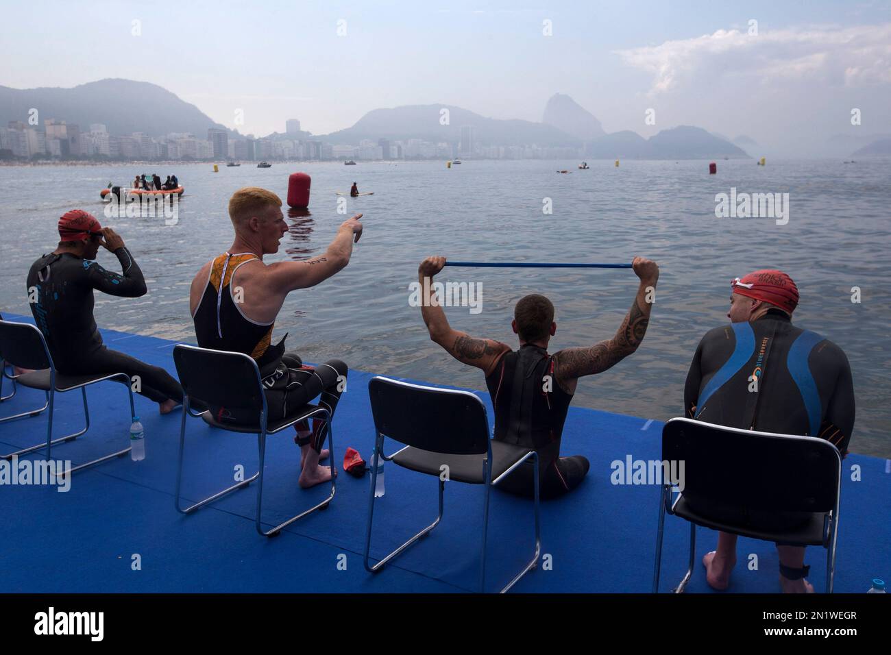 Paratriathletes sit on a floating platform as they get ready for the ...