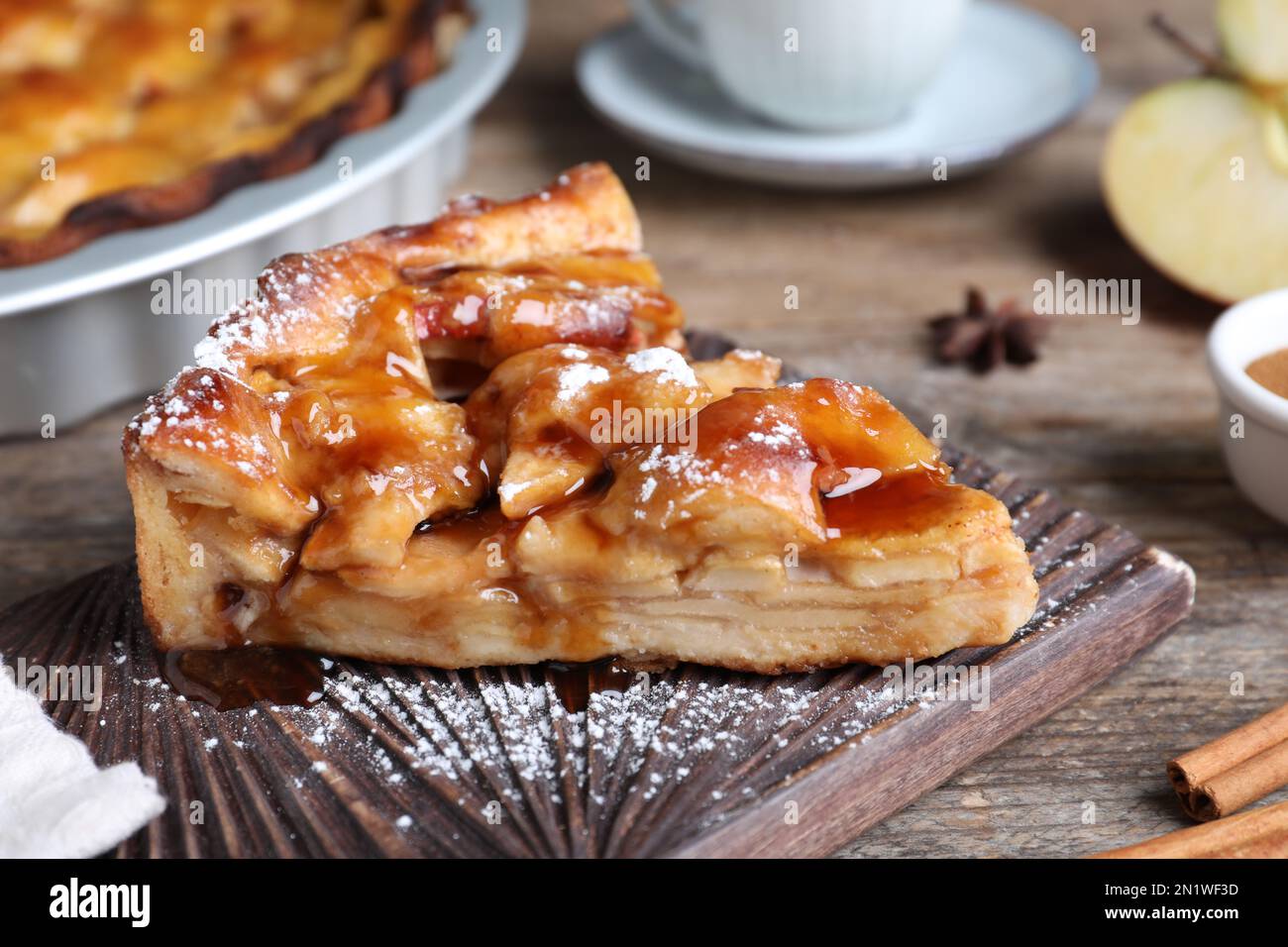 Slice of traditional apple pie served on wooden table, closeup Stock Photo