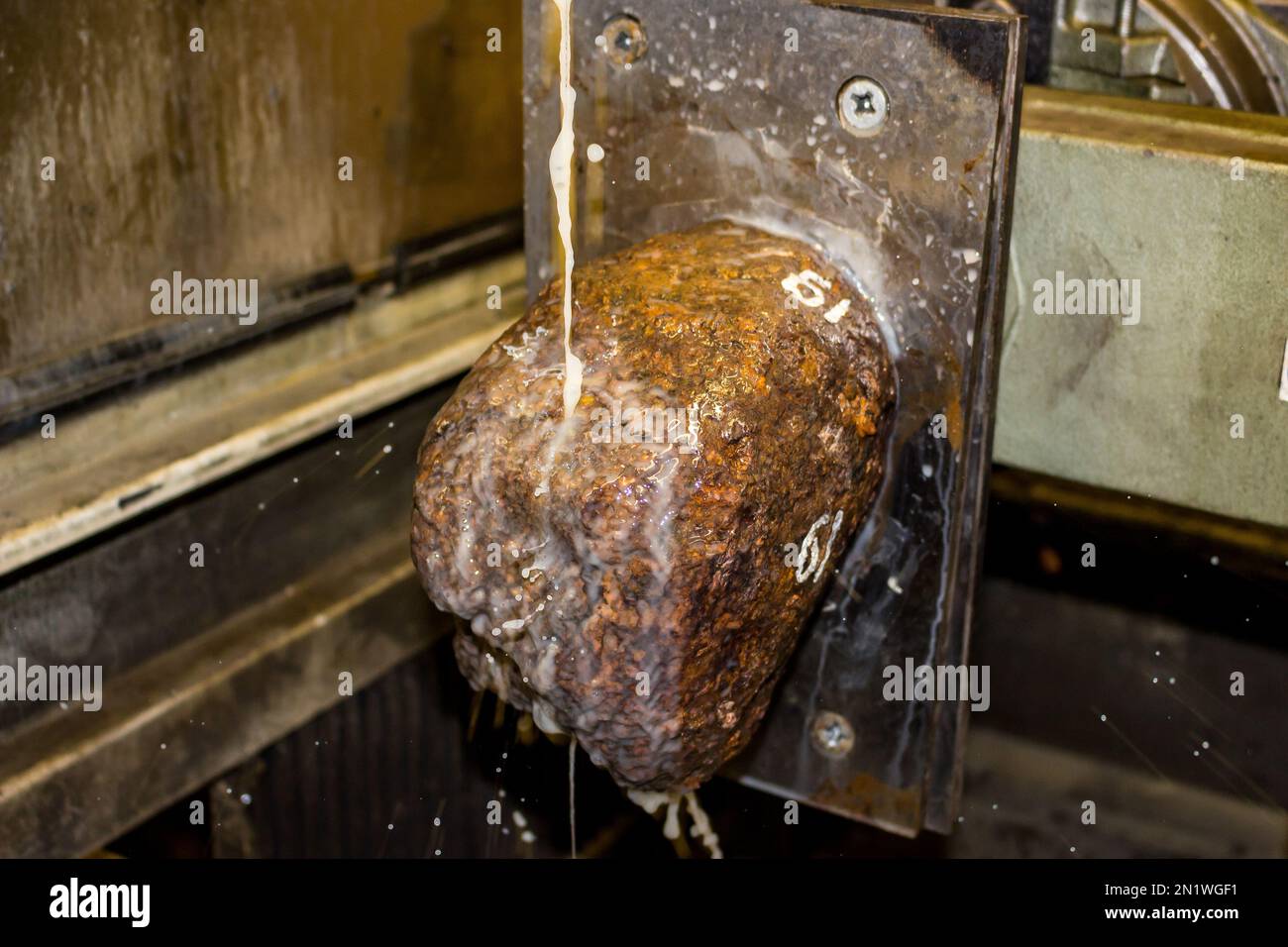 Sawing a meteorite on a machine using a diamond wire with water supply ...