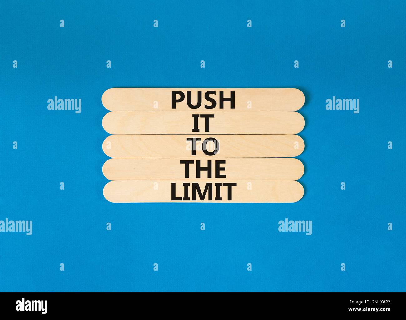 Push it to the limit symbol. Concept words Push it to the limit on wooden stick. Beautiful blue