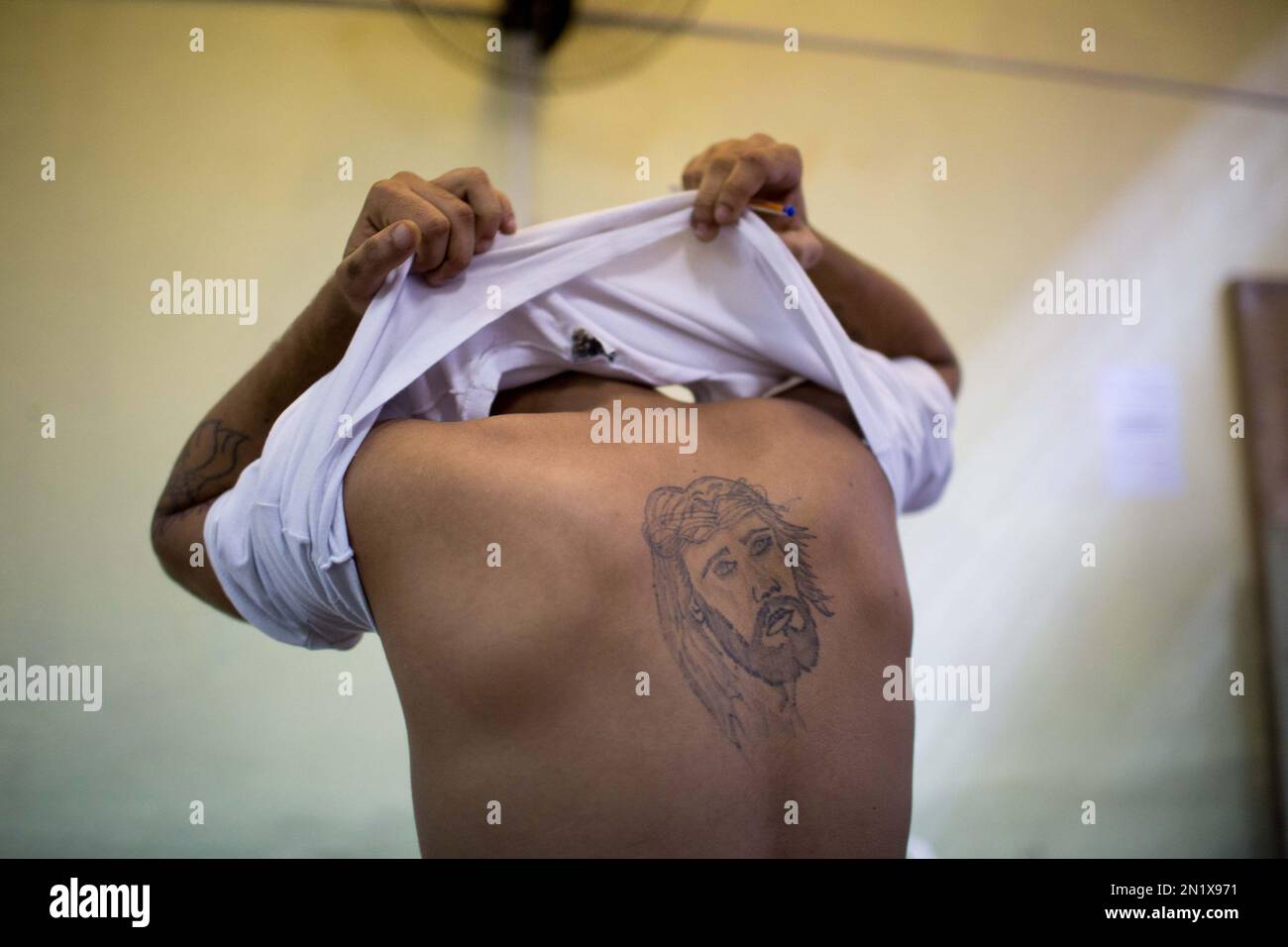 In this July 8, 2015 photo, gay inmate Bruno da Silva shows one of the  tattoos he had made while serving time at the Evaristo de Moraes prison in  Rio de Janeiro,, image size:1300x956