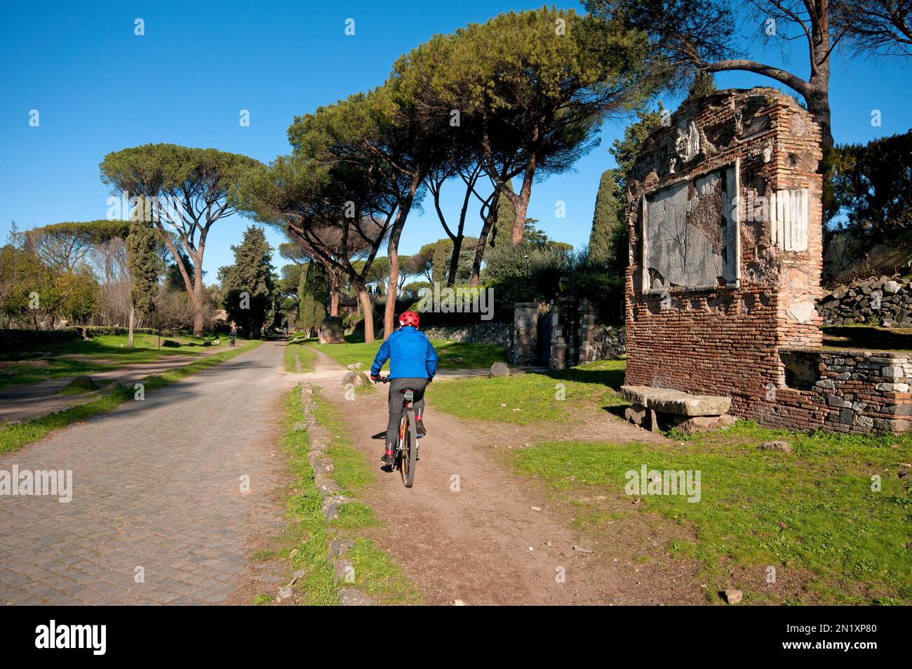 Biking along Via Appia Antica, on the right the tomb of the sons of Sextus Pompeius, Appia Antica Regional Park, Rome, Lazio, Italy Stock Photo