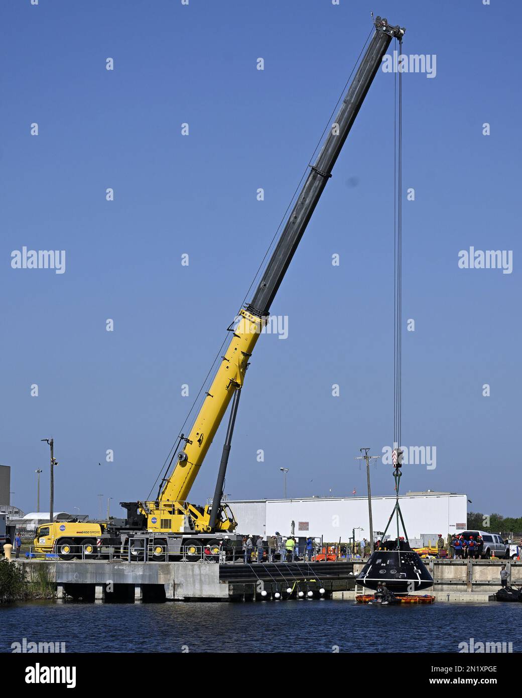 A crane hoists a test article of the Orion spacecraft after NASA and Department of Defense teams conducted recovery training in the Turning Basin at the Kennedy Space Center, Florida on Monday, February 6, 2023. Photo by Joe Marino/UPI Credit: UPI/Alamy Live News Stock Photo