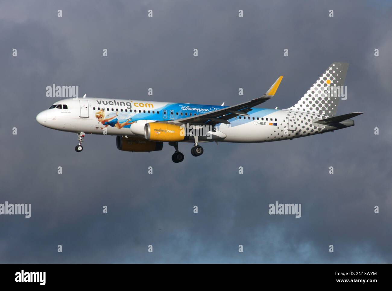 An Airbus A320 of Vueling in a special scheme Disneyland Paris 25 Years arriving at London Gatwick Airport Stock Photo