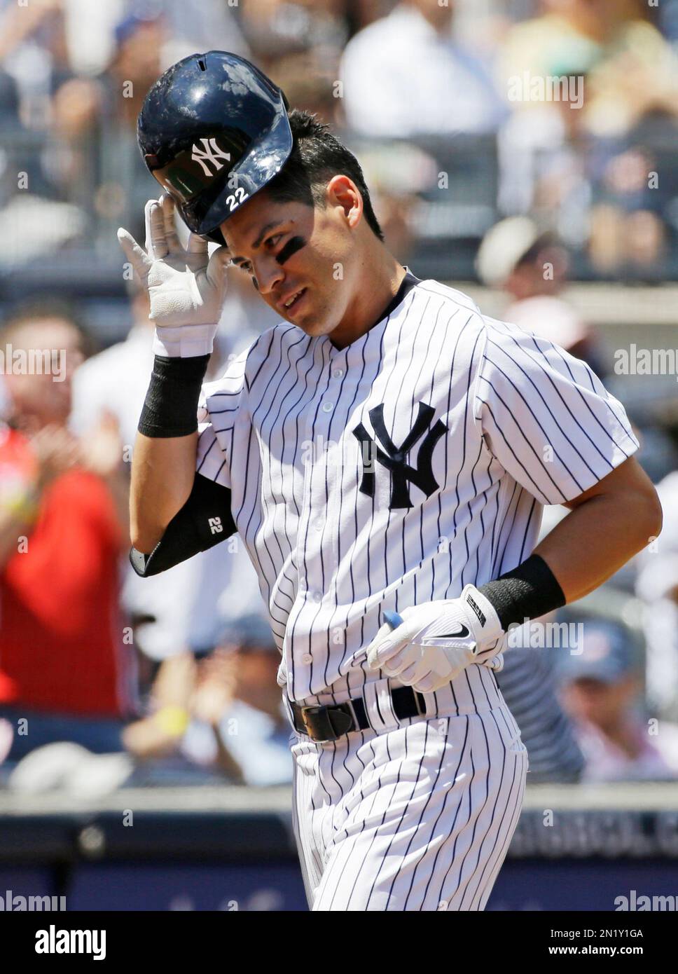New York Yankees Jacoby Ellsbury (22) removes his batting helmet as he  heads to the dugout after hitting a second-inning, solo, home run in a  baseball game against the Baltimore Orioles at