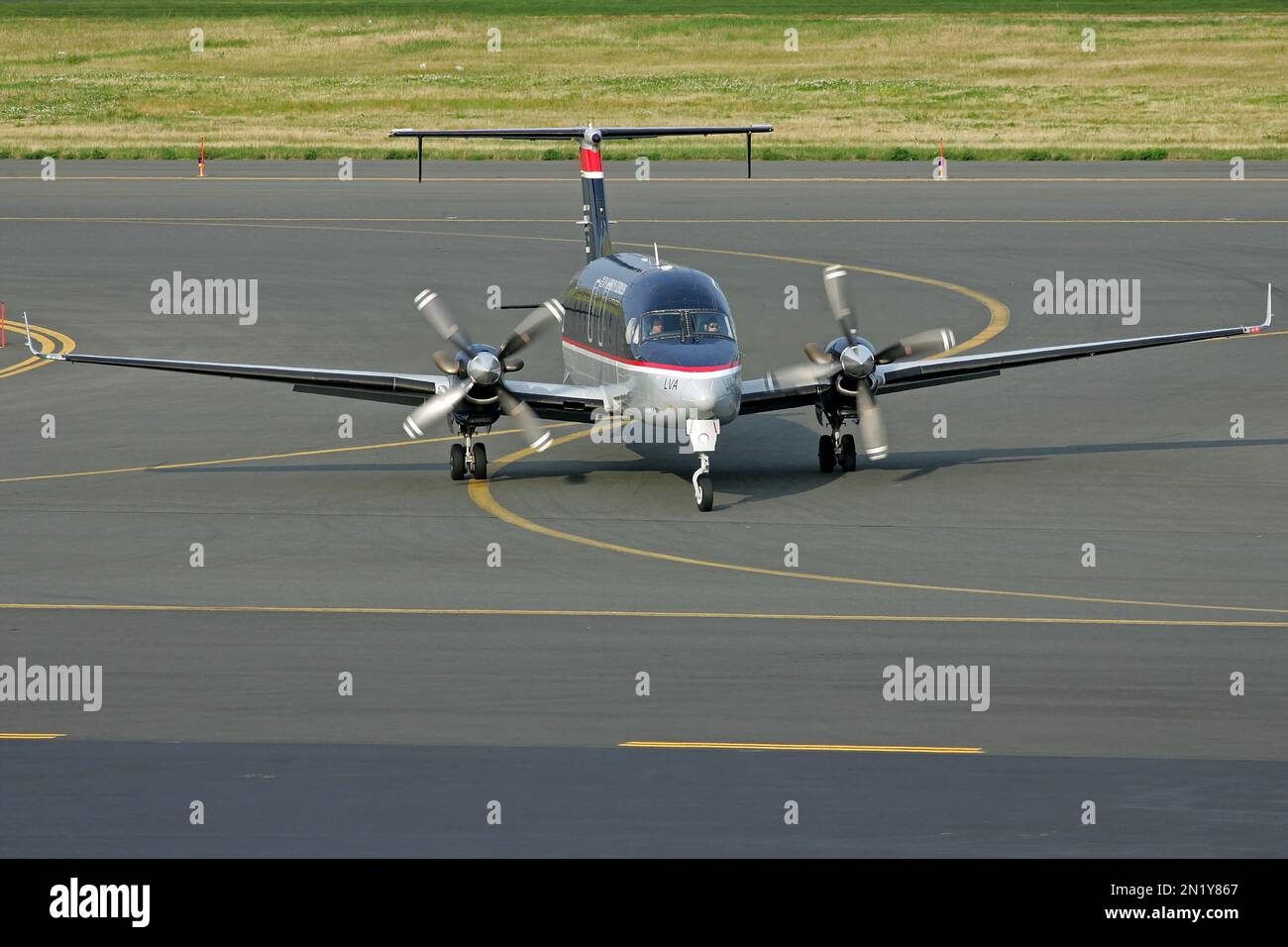 Small propeller plane arrives at airport after landing on runway Stock