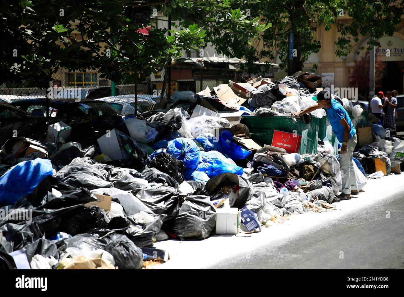 A Lebanese man searches for valuables amongst the garbage on a Beirut