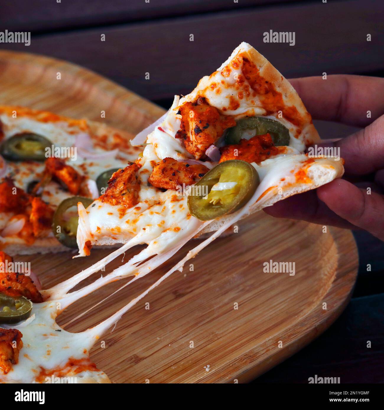 melty cheesy pizza, spiced chicken cubes and mozzarella cheese combination on flat bread, italian food Stock Photo