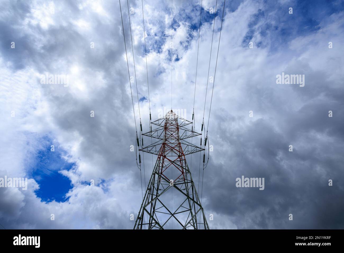 Pylons for electricity with a cloudy sky Stock Photo - Alamy