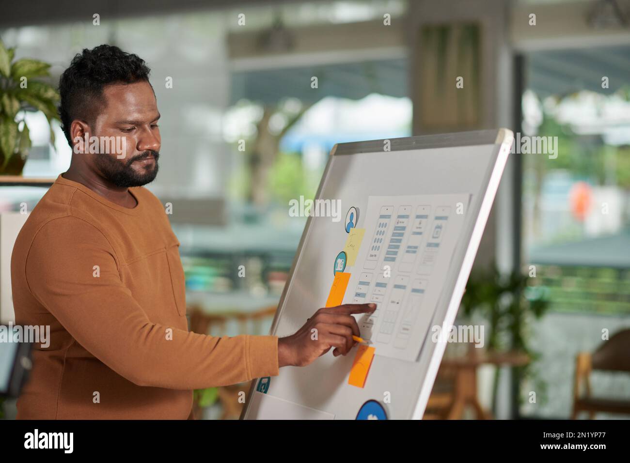 Project manager checking mockups of new mobile application on ...