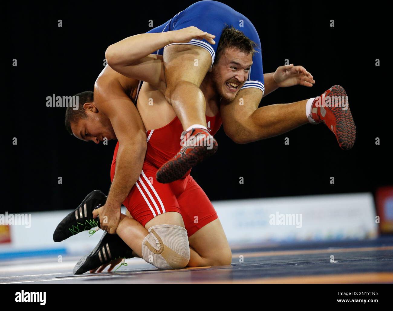 Argentina's Yuri Maier, bottom, competes against Venezuela's Jose Diaz ...