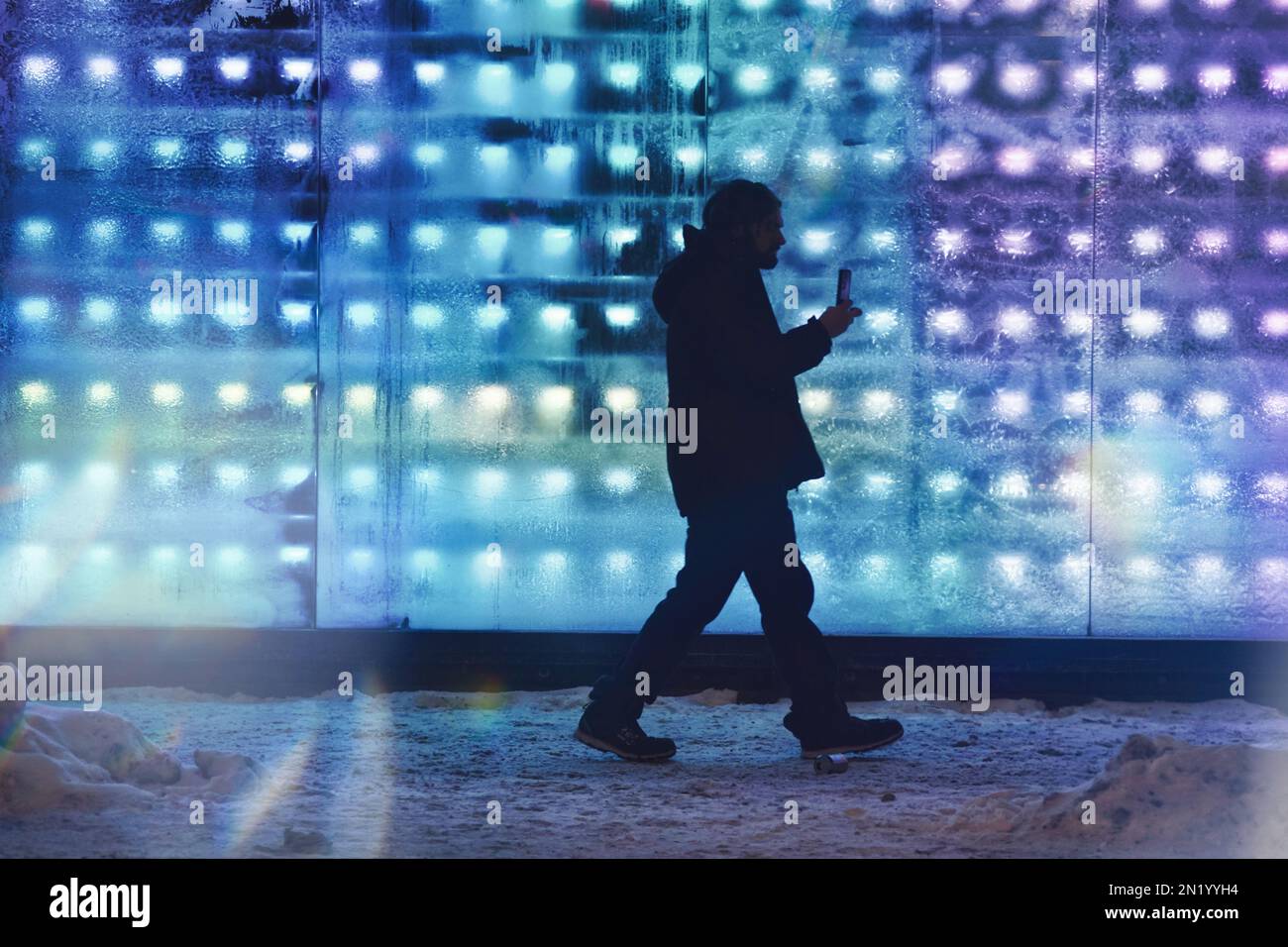 Person walking in front of frosted store front windows in sub-zero weather. Stock Photo