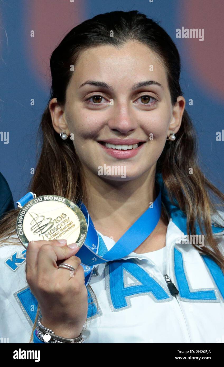 Rossella Fiamingo, of Italy, shows off her gold medal after the epee