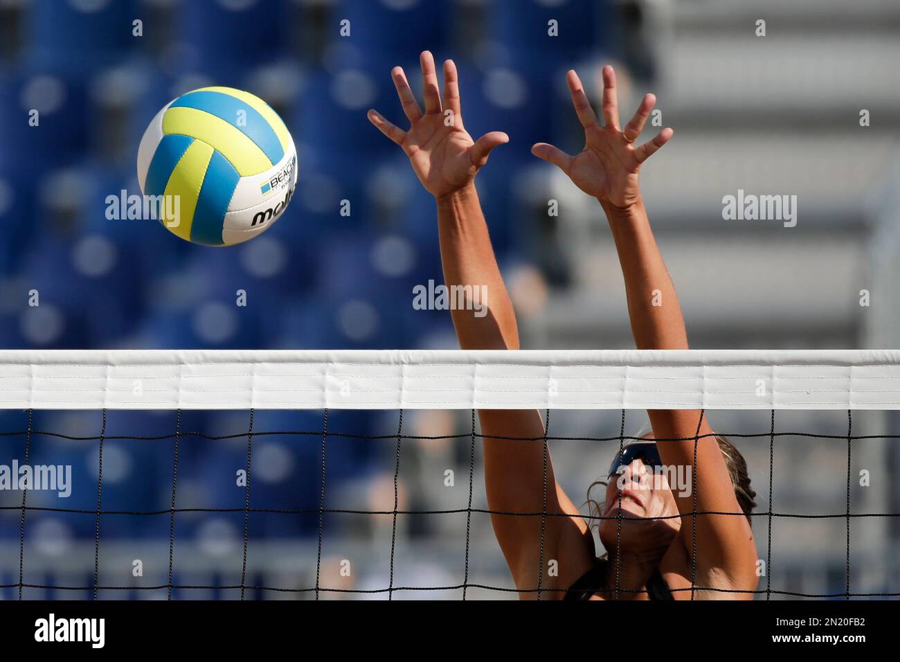 Argentina's Ana Gallay tries to blocks a spikes by Cuba's Lianma Flores