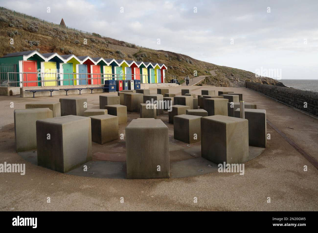 Colourful beach huts and Ammonite water feature, promenade, Barry Island, South Wales, Taken January 2023. Winter. A mist-spraying water feature. cym Stock Photo
