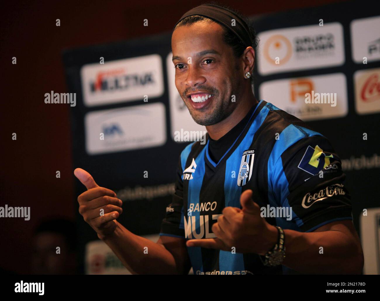 FILE - In this Sept. 12, 2014 file photo, Brazil's Ronaldinho poses for a  photo after slipping on his new Queretaro soccer club jersey at a press  conference in Mexico City. Fluminense