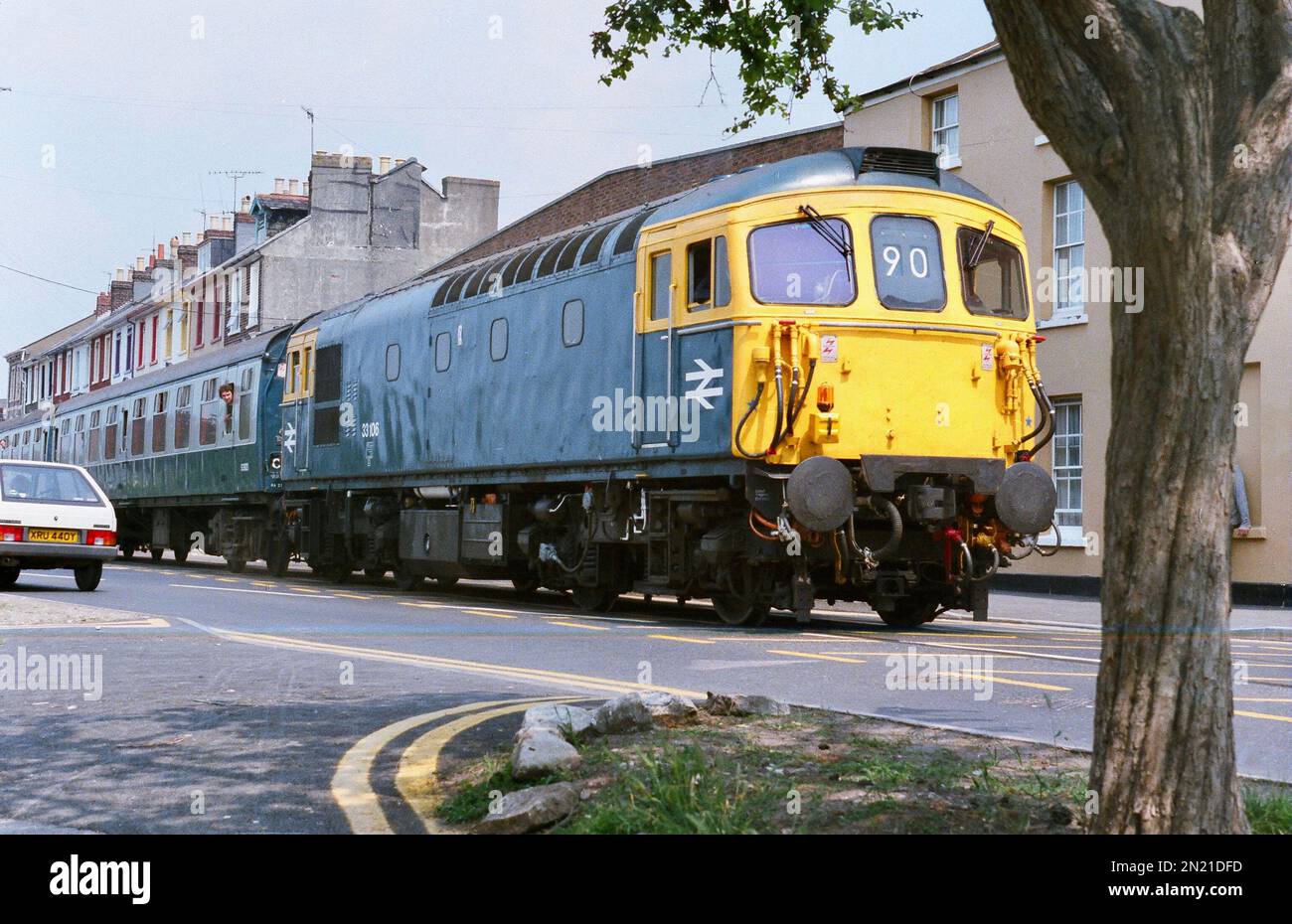 Class 33 'Crompton' 33106 takes the boat train down the legendary Weymouth Quay line on 17th Jun 1984. Stock Photo