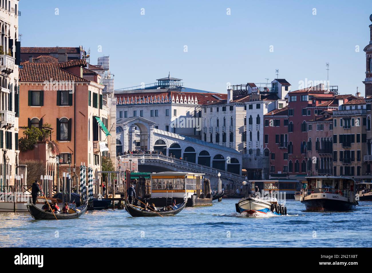 Commercial boats with Rialto Bridge on Canal Grande, Grand Canal, Venice, Veneto, Italy, Europe Stock Photo