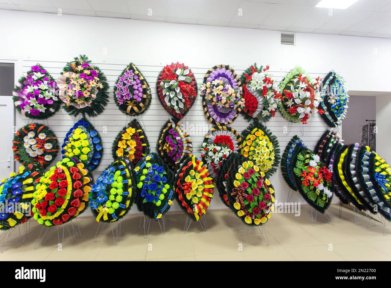 Interior of shop with funeral accessories. Shop selling coffins, funeral wreaths and flowers. Stock Photo