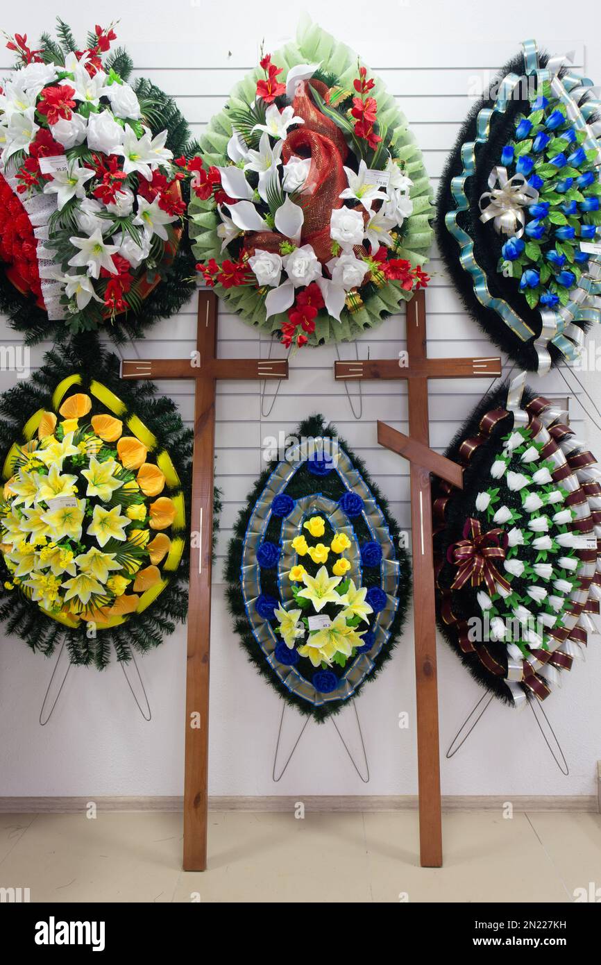 Interior of shop with funeral accessories. Shop selling coffins, funeral wreaths and flowers. Stock Photo